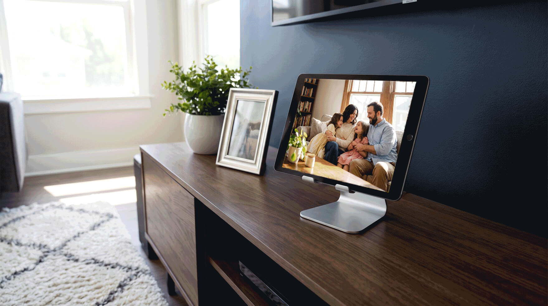 An iPad on a stand in a living room, playing a slideshow of photos with Encore Frame